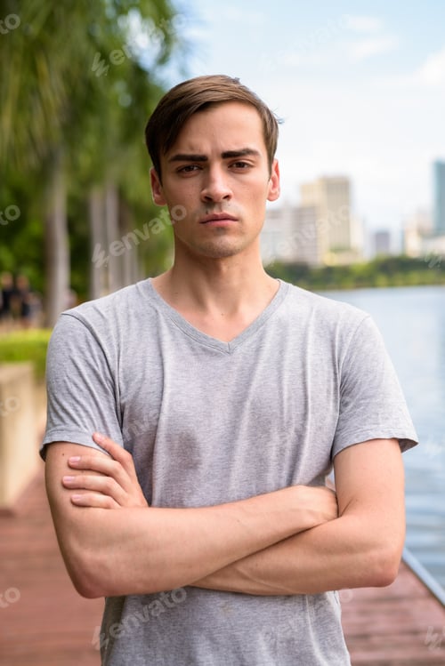 Preview: Young handsome man relaxing at the park