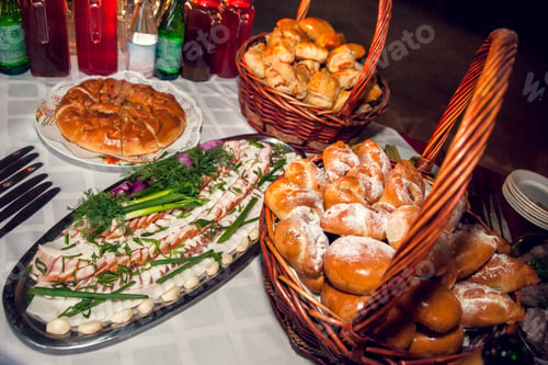 Preview: Table set with snacks: pies pirozhki with stuffing, sliced lard with fresh herbs