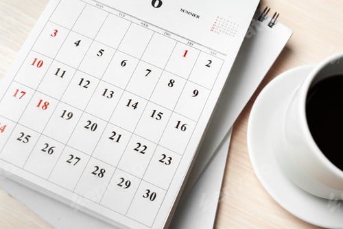 Preview: June calendar on a desk with a cup of coffee during morning hours