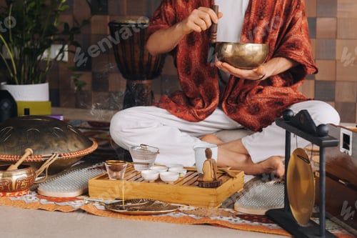 Preview: Tibetan singing bowl in the hands of a man during a tea ceremony