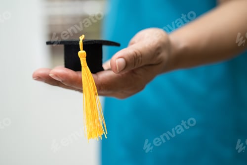 Preview: Asian doctor study learn with graduation gap hat in hospital ward
