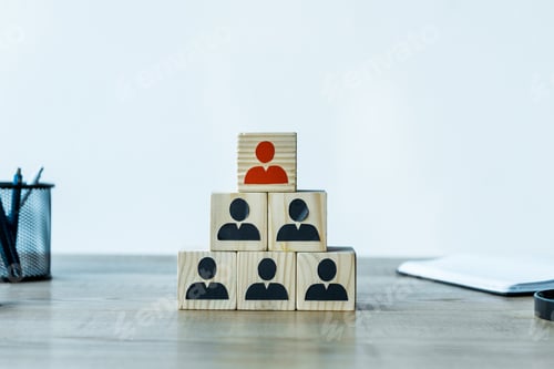Preview: wooden cubes as human resources strategy near stationery on desk