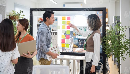 Preview: Group of young Asian business people team meeting in modern office working