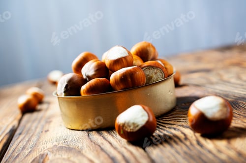 Preview: Hazelnuts on wooden backdrop. heap or stack of hazelnuts. Hazelnut background, healty food