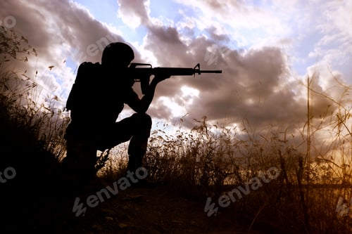 Preview: Soldier with machine gun patrolling outdoors. Military service