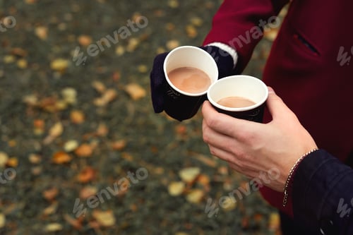 Preview: Close up of hands holding paper cups of coffee