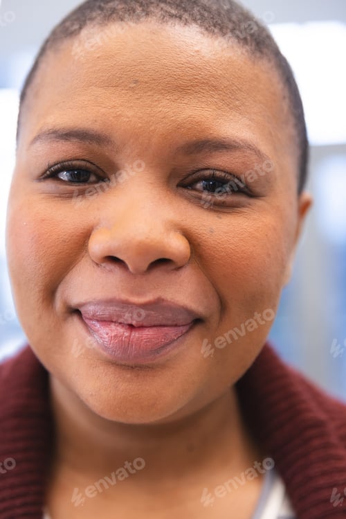 Preview: Portrait of happy african american female patient in waiting room at hospital