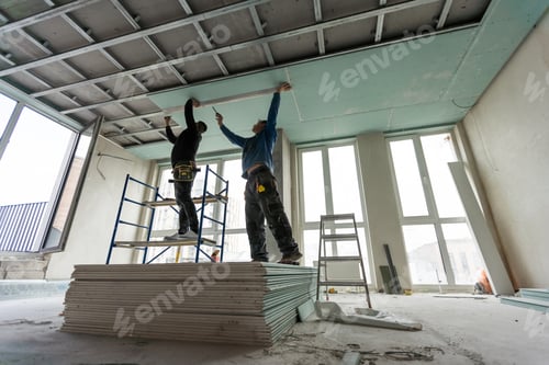 Preview: Construction worker assemble a suspended ceiling with drywall and fixing the drywall to the ceiling