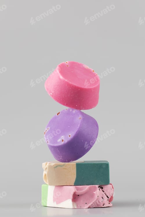 Preview: Natural handmade soap. Bright pieces of soap balance on a grey background.