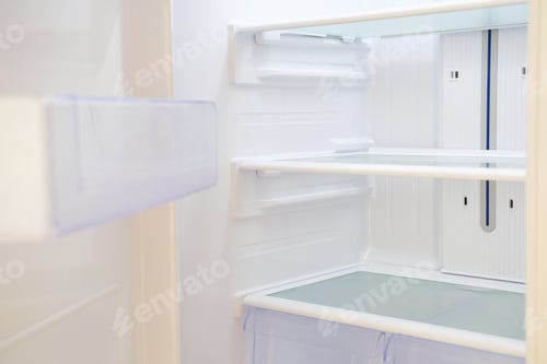 Preview: Modern white open refrigerator close-up with empty shelves.