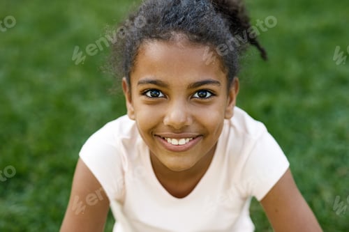 Preview: Close up portrait of cute smiling girl, sitting on grass