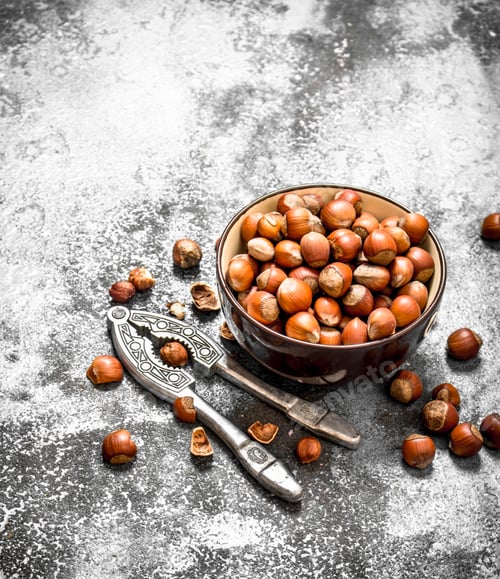 Preview: Hazelnuts in a bowl with a Nutcracker.
