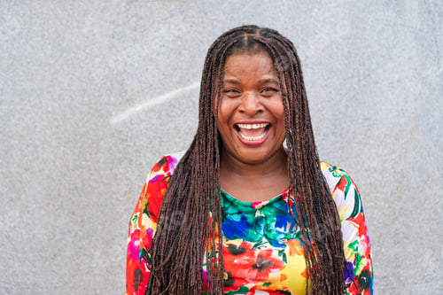 Preview: Cheerful black woman laughing in the city