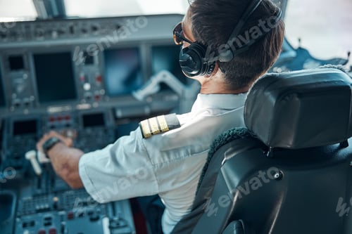 Preview: Male pilot flying passenger plane on sunny day