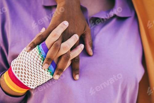Preview: Gay women couple holding their hands at pride parade event
