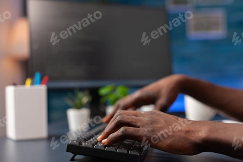 Preview: Closeup of african american employee hand programming binary code
