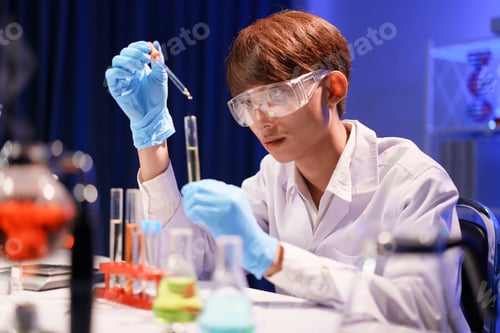 Preview: Scientists working in Laboratory using pipette dropping liquid sample into test tube.