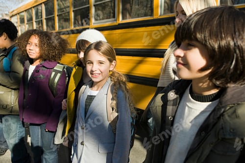 Preview: Group of children smiling by the school bus on a sunny day
