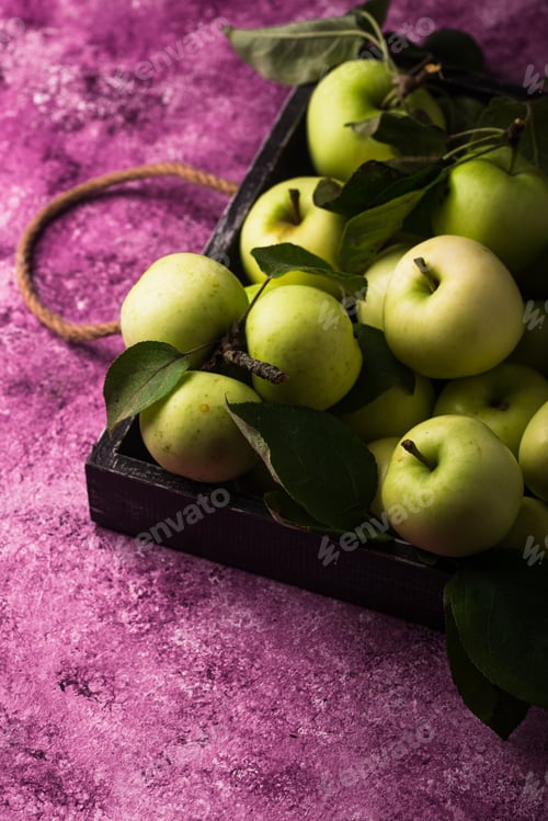 Preview: Fresh ripe green apple in purple background.