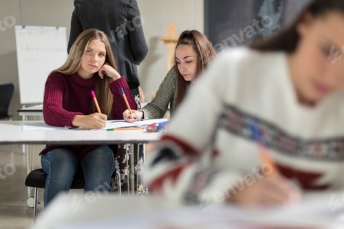 Preview: Teenage girls sitting in class