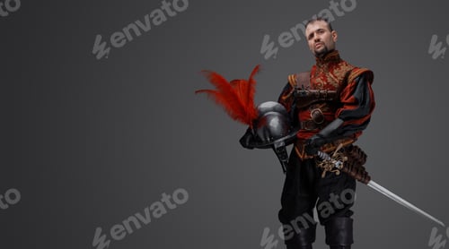 Preview: Handsome musketeer man dressed in costume holding helmet