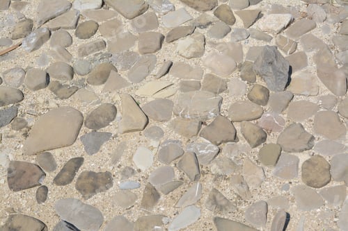 Preview: Surface of ground with different grey stones as background, above view