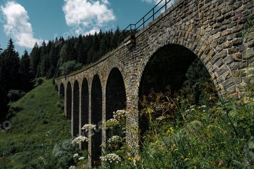 Preview: Stone viaduct bridge over lush landscape
