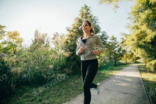 Preview: Fit beautiful woman jogging in park
