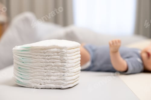 Preview: Newborn Baby Resting Peacefully with Diapers Stack
