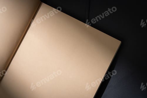 Preview: Stack of Magazines on a Black Leather Couch in Soft Light
