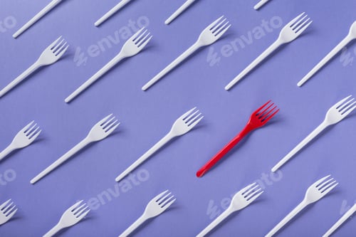 Preview: Top view on plastic forks on violet background