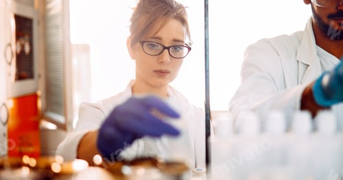 Preview: Attractive student of chemistry working in laboratory