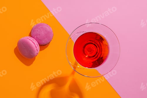 Preview: Pink summer cocktail with sweet cookies on color abckground