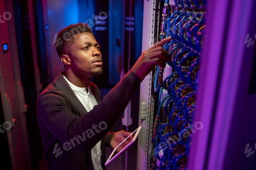 Preview: Concentrated Black IT Engineer Checking Connection