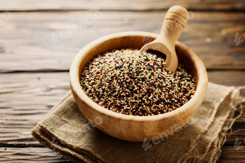 Preview: Mix of raw red, white and black quinoa on thw wooden table