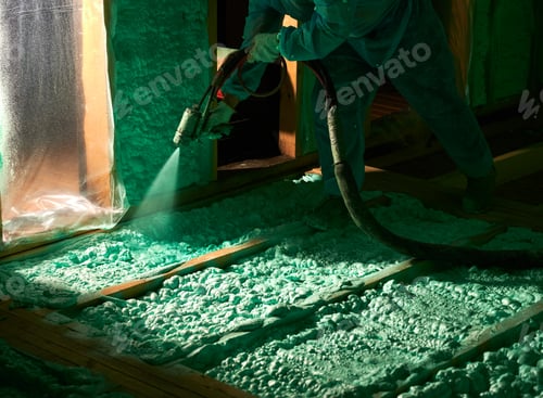 Preview: Worker spraying polyurethane foam for insulating wooden frame house.