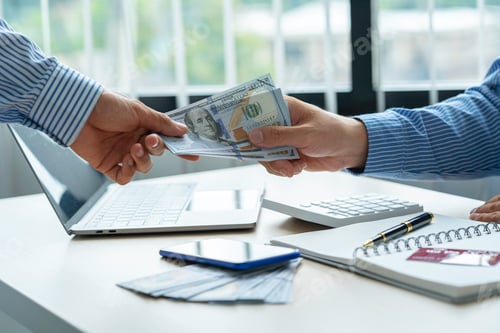Preview: Two businessmen give and take US dollar banknote.US dollar is the main and popular currency of excha