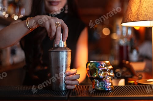 Preview: girl bartender prepared a delicious alcoholic fresh sweet cocktail and serves it at the bar