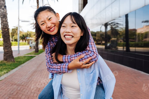 Preview: Happy beautiful chinese women friends bonding in the city