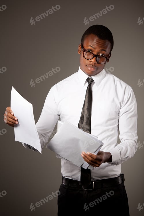 Preview: Young positive handsome african businessman in stylish shirt, tie and glasses standing with