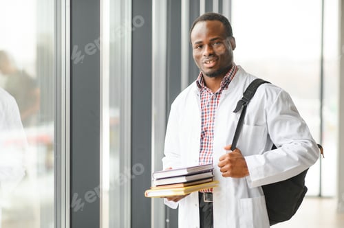 Preview: Medical Professional Holding Books in Hospital Setting