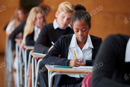 Preview: Teenage Students In Uniform Sitting Examination In School Hall