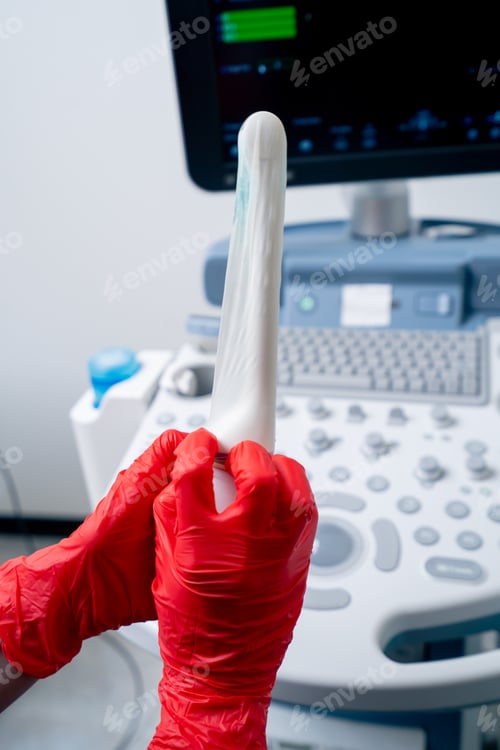 Preview: close-up in the clinic gynecological office ultrasound machine doctor puts on a condom