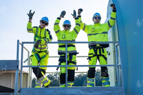 Preview: Confident engineers celebrating on platform