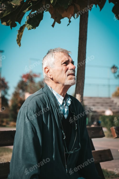 Preview: Old man sitting on a bench