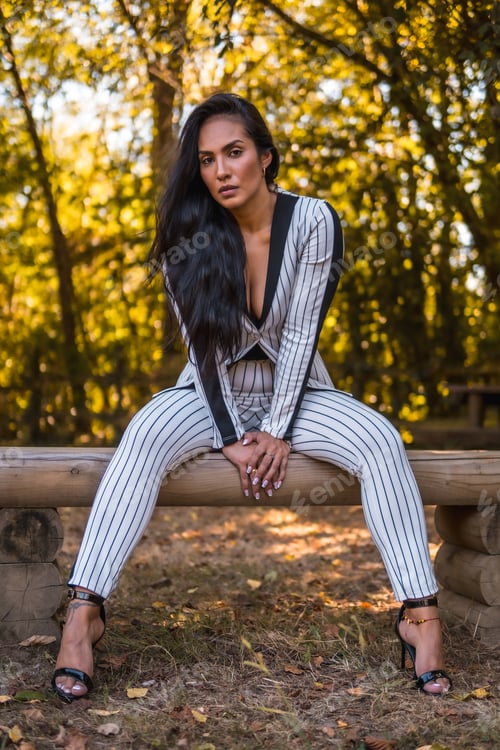 Preview: Summer lifestyle, young Latin brunette girl in a very elegant white suit with black stripes