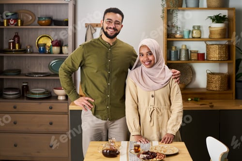 Preview: Portrait of Young Adult Muslim Man and Woman Smiling Together in Kitchen
