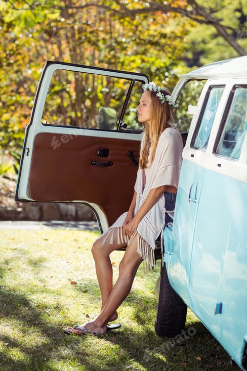 Preview: Woman with flower wreath sitting in campervan