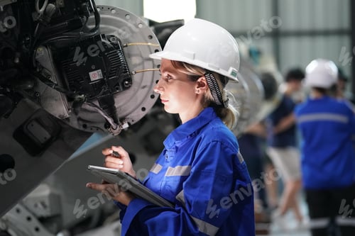 Preview: Robotics engineer working on maintenance of robotic arm in factory warehouse. Business technology.