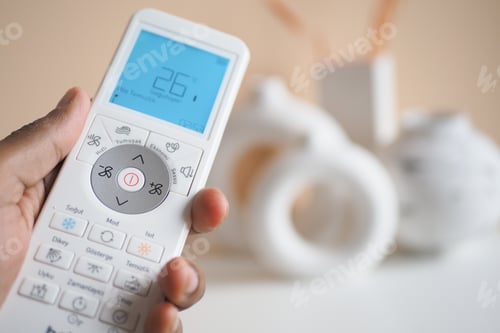 Preview: Close up of man hand holding air condition remote.